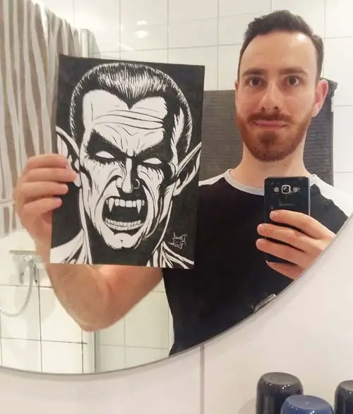 holding a drawing in a mirror